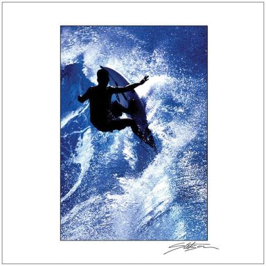 Silhouette of a surfer performing a jump above ocean waves.