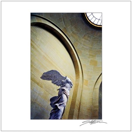 Winged Victory statue under a circular skylight in an ornate interior.