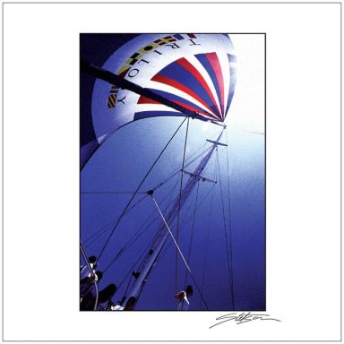 Colourful hot air balloon soaring against a bright blue sky with visible ropes and support structure.