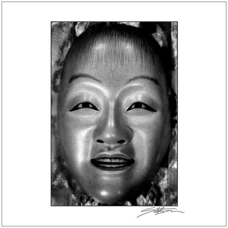 A smiling traditional mask with smooth features and intricately detailed texture.