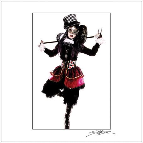 Person in a theatrical costume with a hat, face paint, and playful, bold attire.