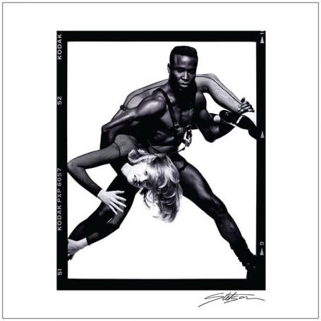 A dynamic black and white portrait of a man lifting a woman in an expressive pose.