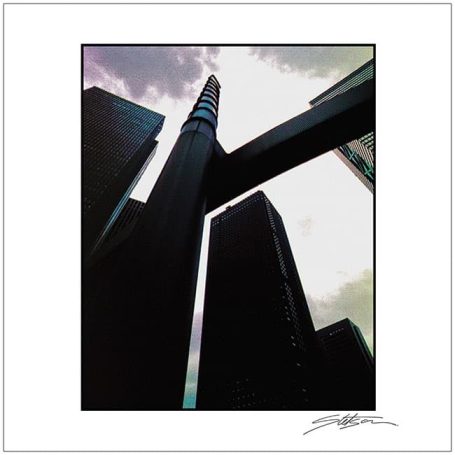 Skyscrapers reaching towards a cloudy sky, viewed from a low angle.