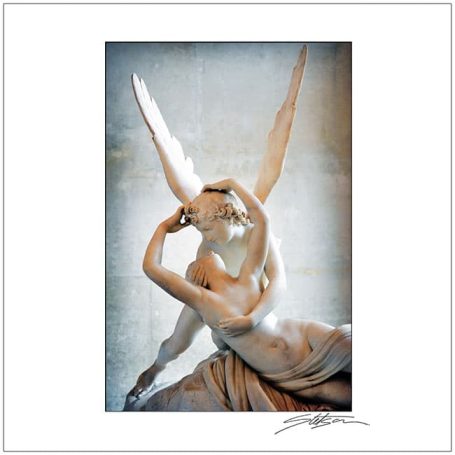 A statue of a winged figure embracing another figure, showcasing intricate details.