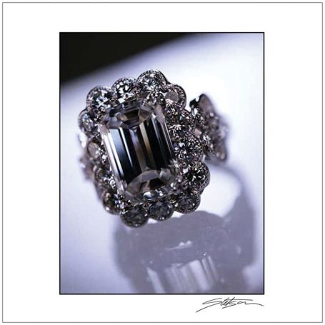 A dazzling ring featuring a central emerald-cut stone surrounded by delicate gems.