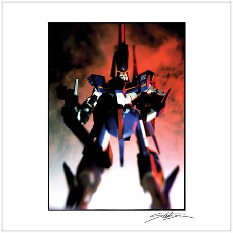 A towering robot in red and blue against a smoky, dramatic background.