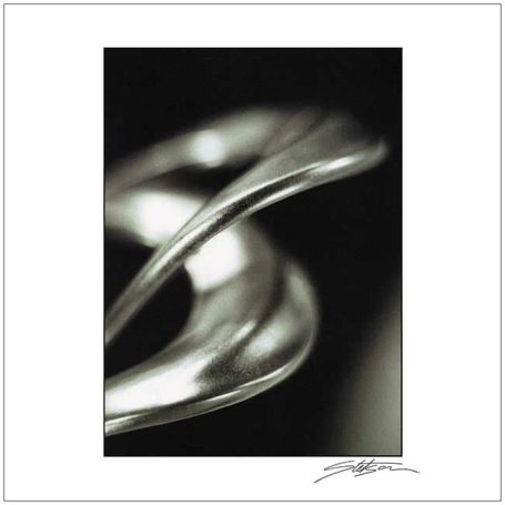 Abstract silver curves against a dark background.