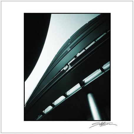 Abstract architectural view of a curved structure against a light background.