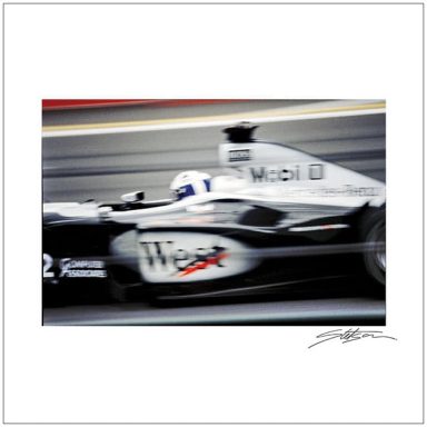 A high-speed racing car in motion, featuring a sleek black and white design.