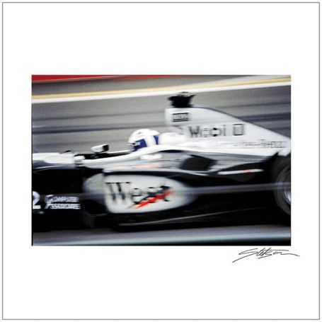 A high-speed racing car in motion, featuring a sleek black and white design.