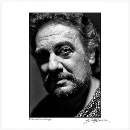 Black and white portrait of a man with curly hair and a thoughtful expression.