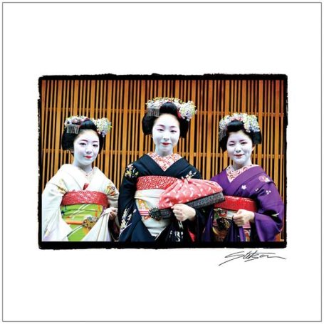 Three women in traditional Japanese kimono, with elaborate hairstyles and make-up.