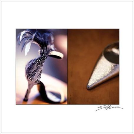 A decorative bird figure alongside a metallic tool with a pointed end.