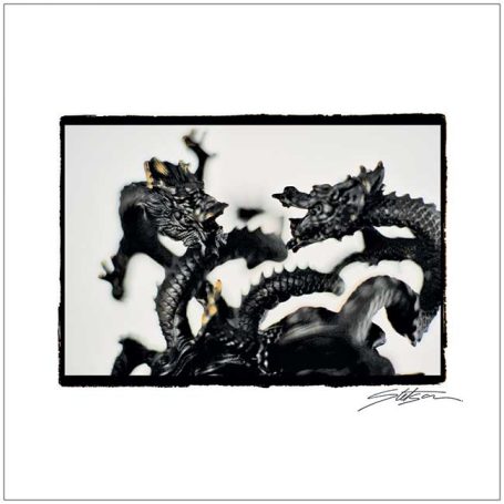 Two entwined dragon sculptures in black against a white background.