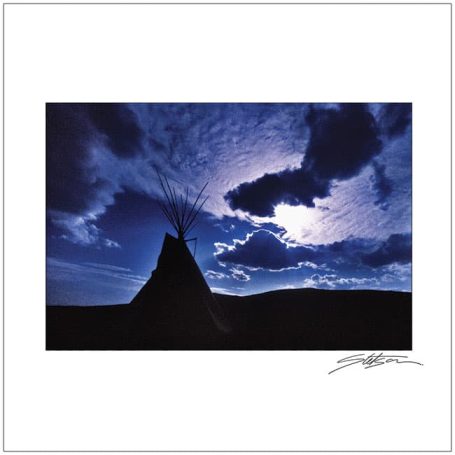 Silhouette of a teepee against a dramatic, cloudy sky.