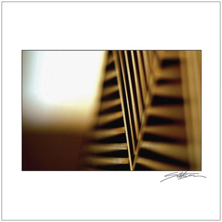 Close-up of wooden slats with soft light in the background.