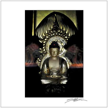 Buddha statue with intricate detailing and a serene expression, surrounded by decorative elements.