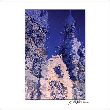 Abstract reflections in blue and white water, creating a textured, fluid pattern.