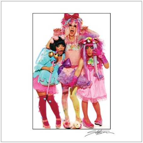 Three individuals in vibrant, playful outfits with bright colours and accessories.
