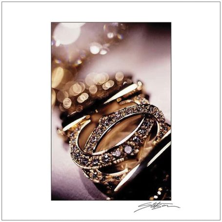 Close-up of elegant gold rings with sparkling diamonds arranged stylishly.