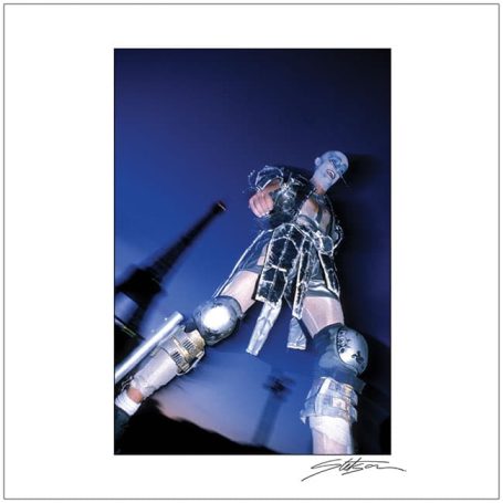 A futuristic figure in metallic attire poses against a dark background.