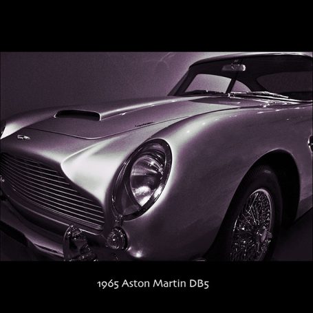 1965 Aston Martin DB5 with sleek silver body and distinctive grille.