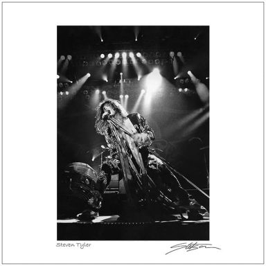 A performer singing on stage with dramatic lighting and a dynamic pose.