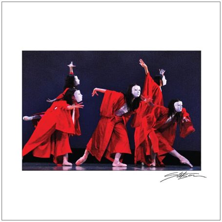 Five dancers in red costumes, wearing white masks, performing on a dark stage.