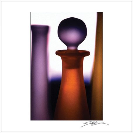 Colourful glass objects in varying shapes, featuring a prominent orange piece.