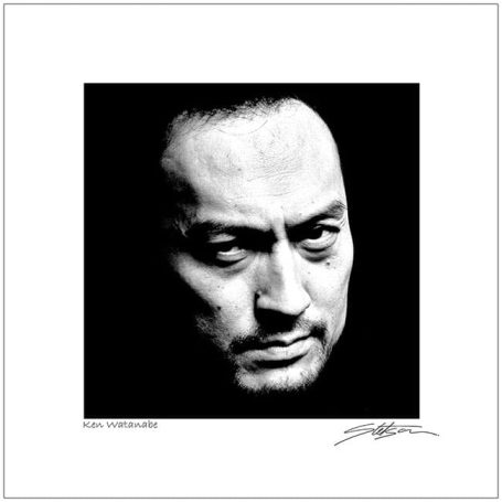 Close-up of a serious man with intense expression in black and white.